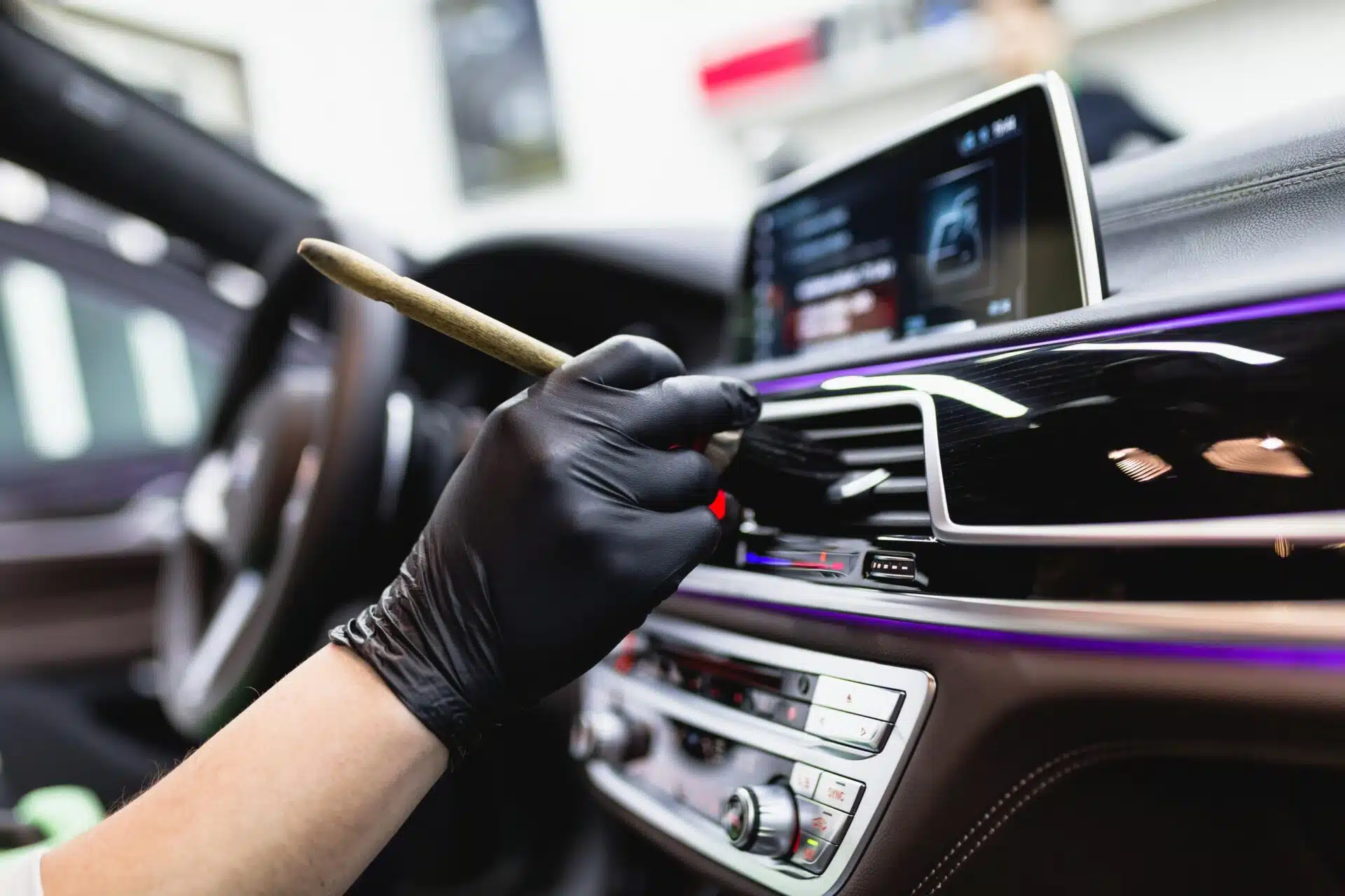 Technician detailing car bodywork